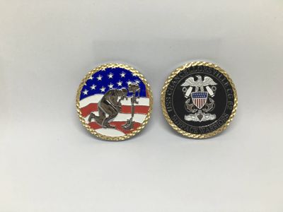 Two gold-rimmed coin faces with US flag colors, service-style lettering and a central animal emblem