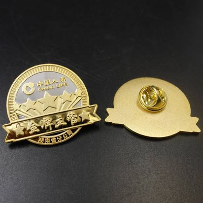 Gold circular recognition badge with raised stars Chinese inscription and butterfly clutch shown beside it