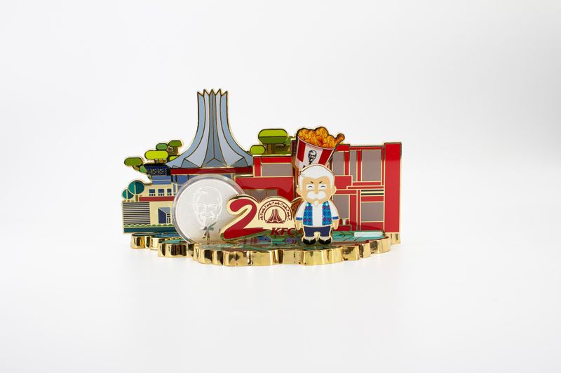 Layered red anniversary cityscape fridge magnet with gold buildings and cartoon figure