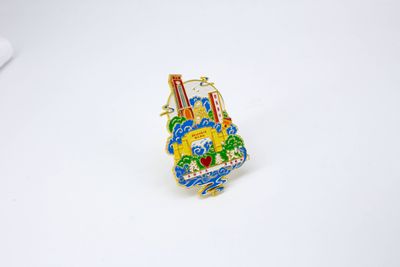 Small colorful city landmark souvenir with stacked buildings and bright blue green details