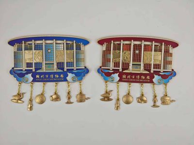 Blue and red architectural souvenir magnets each featuring small hanging gold icons