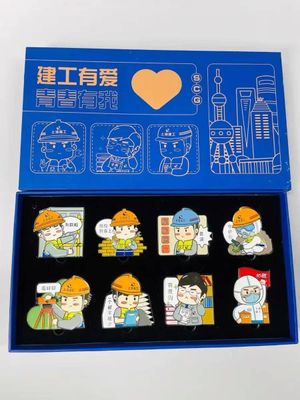 Blue presentation box with eight cartoon construction worker badges and printed lid