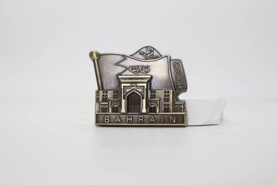 Antique silver look Bahrain souvenir with building façade and flag motif