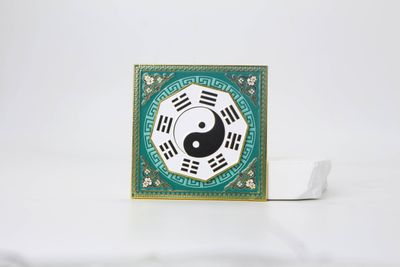 Green square yin yang eight trigrams magnet with ornate patterned border