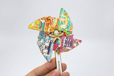 Colorful multi bladed landmark pinwheel held by its narrow stem