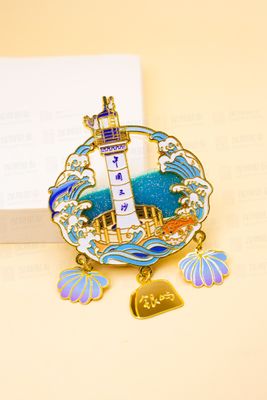 Gold outlined lighthouse and ocean waves magnet with hanging seashell charms