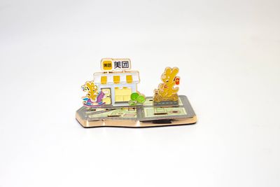Miniature yellow delivery branded storefront souvenir with colorful riders and food shop