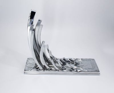Polished silver abstract trophy with multiple upward sweeping curved metal-like forms on textured base