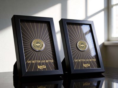 Two black rectangular frames containing gold sunray designs and circular Keeta logos with EAT BETTER LIVE BETTER text